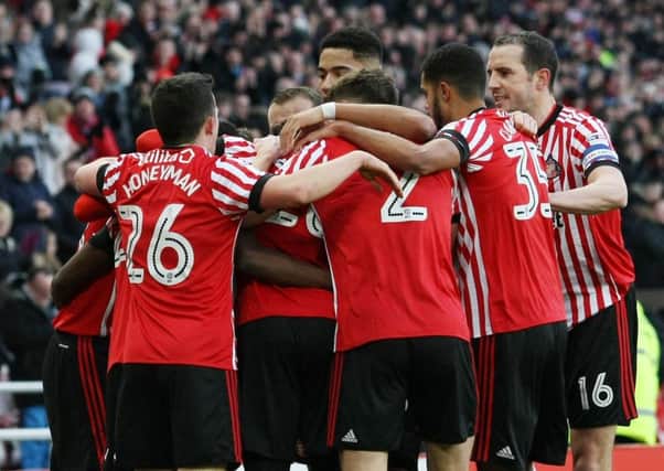 Sunderland players mob scorer Joel Asoro.