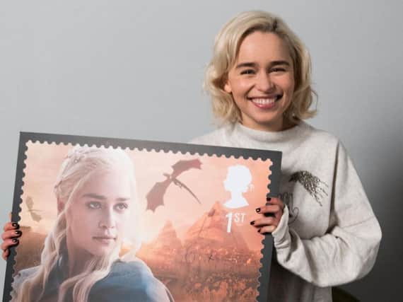Actress Emilia Clarke with a replica enlargement of the stamp.