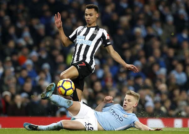 Newcastle United's Jacob Murphy and Manchester City's Oleksandr Zinchenko battle for the ball.