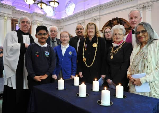 Mayor Coun Olive Punchion and Mayoress light candles with others at the Holocaust Memorial Service at South Shields Town Hall.
