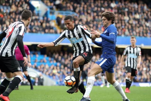 Isaac Hayden and Chelsea's Marcos Alonso battle for the ball in yesterday's FA Cup clash.