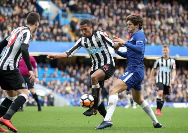 Isaac Hayden and Chelsea's Marcos Alonso battle for the ball in yesterday's FA Cup clash.