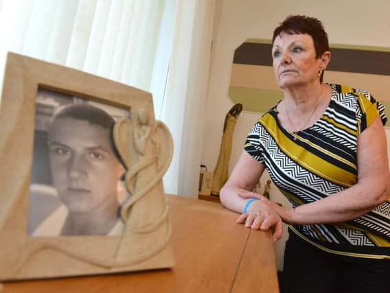Pat McDougall with a picture of murdered grandson Glen Corner.