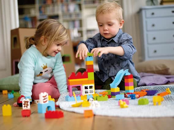 Young children having fun with Duplo