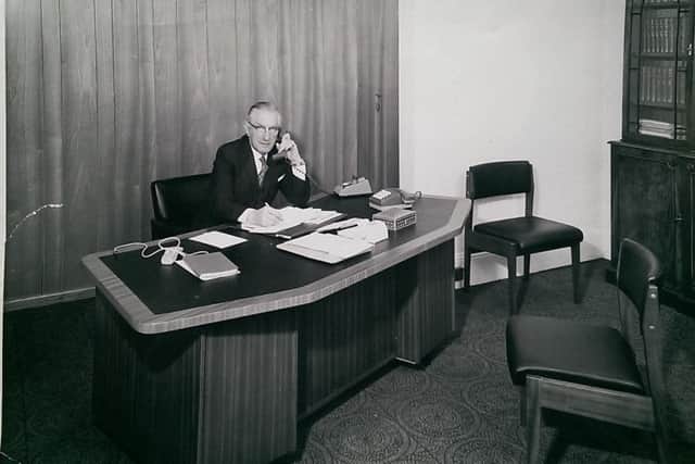 Charles Hare in newly opned office of Tyne Commercial BS, c 1970.