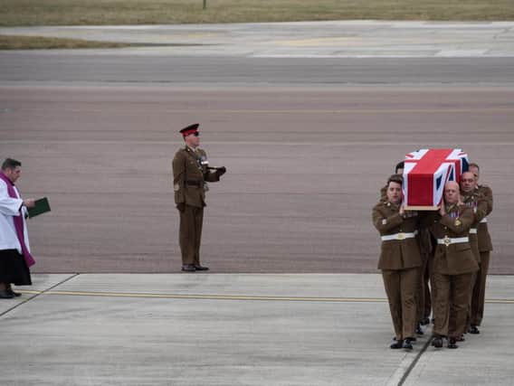 Capt Sprouting's coffin is carried from the plane