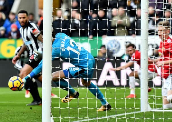 Martin Dubravka makes a save for Newcastle.