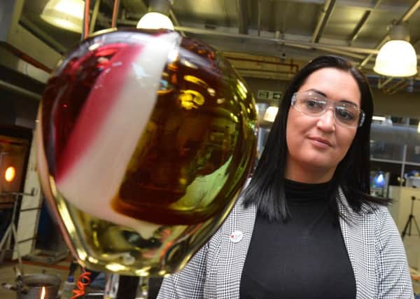 Gemma Lowery helps to make a glass award for Jermain Defoe which he will be given at this month's North East Football Writers Association Awards.