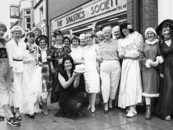 Staff from the Spastics Society shop, in Fowler Street, South Shields, celebrate the shop's second birthday in fancy dress. Manageress Lilian Dimopoulos, front, with the birthday cake.