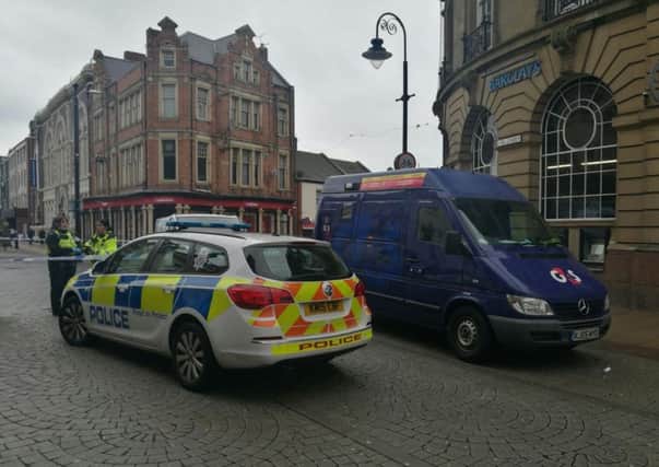 Police at the scene of the knife point robbery in King Street