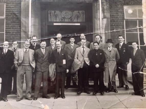 Mr R Graham, front row, third from the right, in the dark suit.