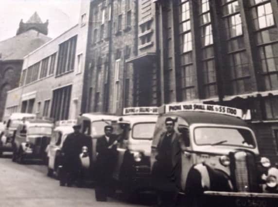 Ronnie Graham next to the van in the middle of the photo.
