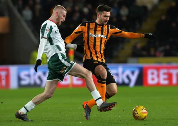 Barnsley scorer Oli McBurnie (left) takes on Hull midfielder Jon Toral tonight. Picture by Bruce Rollinson