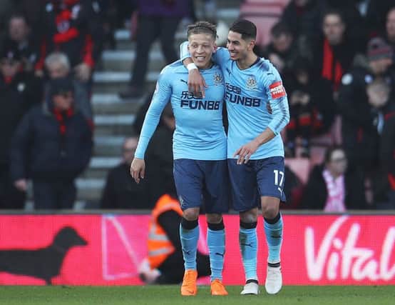 Dwight Gayle (left) celebrates scoring his second goal at Bournemouth.
