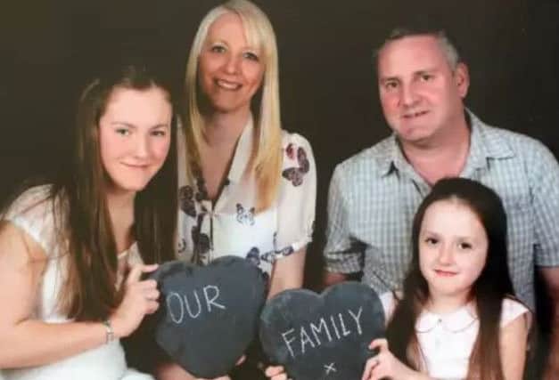 Emily with her mam Helen, dad Paul and younger sister Sophie