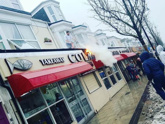 The Colemans sign on fire. Photo by Sophie Heilbron.