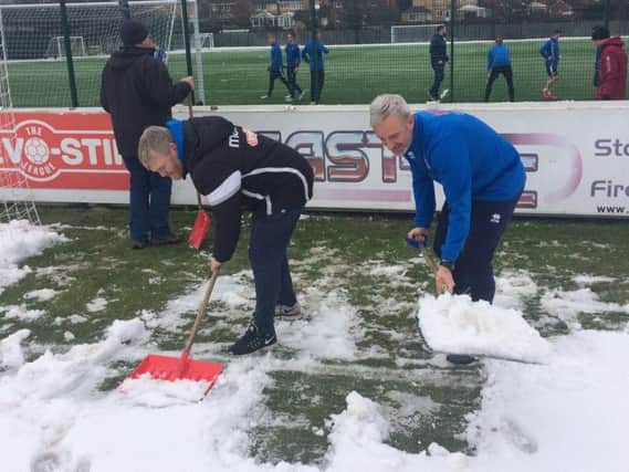 Joint managers Graham Fenton and Lee Picton clear some of the snow.