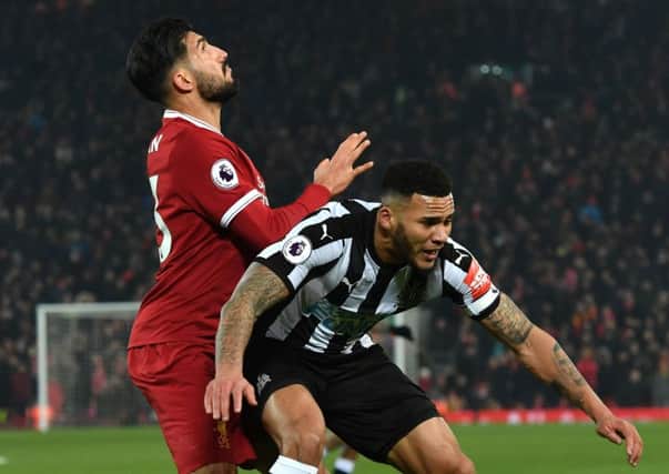 Liverpool's Emre Can (left) and Newcastle United's Jamaal Lascelles battle for the ball.