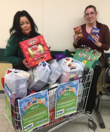 Wendy Kassim, from Morrisons, with Amy, from Hope 4 Kidz, and some of the may eggs that were donated to this year's Easter Egg Appeal.