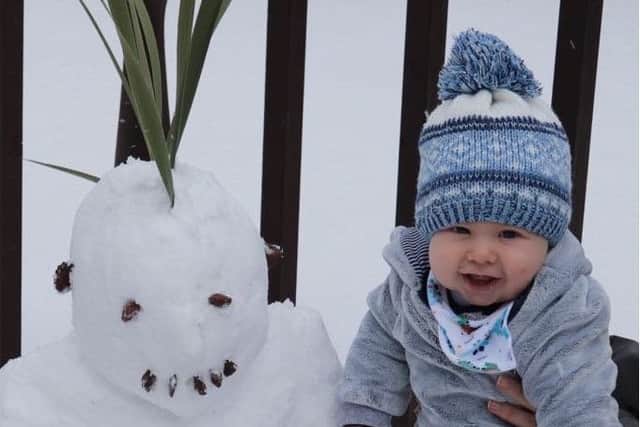 Baby Luke Gates with his punk snowman.