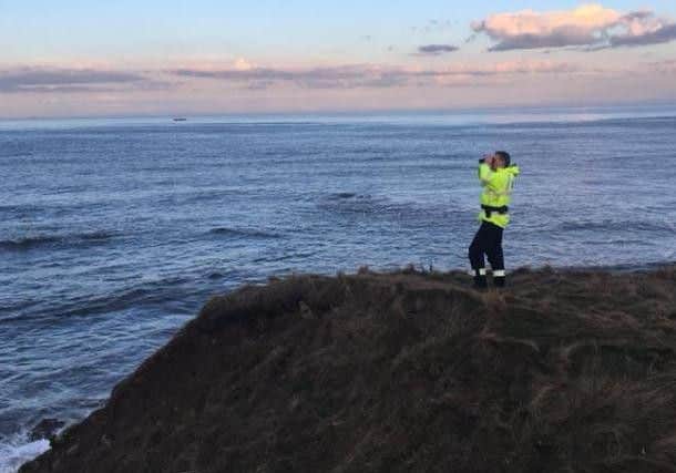 A member of Sunderland Coastguard Rescue Team searching the sea from the clifftops yesterday.