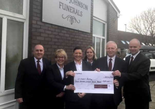 Peter Johnson Funeral Directors present a cheque to St Clares Hospice