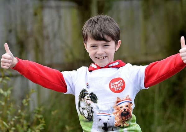 Daniel Rowell (8) at the end of his 100 mile walk in aid of Sports Relief. Picture by Frank Reid