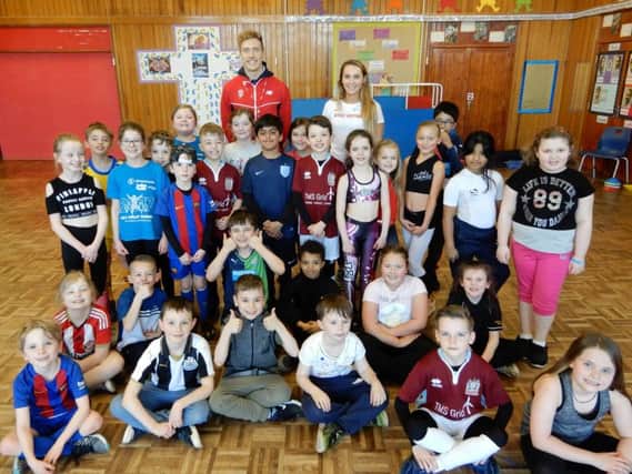 Pupils at St Bede's RC Primary in South Shields with international athletes Lucy Turner and Scott Hall.