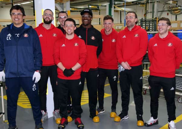 Chris Coleman and players on their trip to the Caterpillar plant in Peterlee this week.