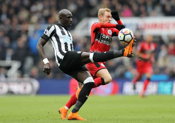 Mohamed Diame (left) and Huddersfield Town's Alex Pritchard battle for the ball.