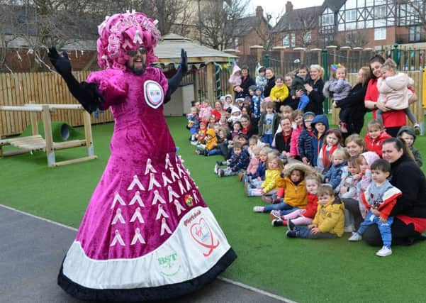 Big Pink Dress fundraiser Colin Burgin-Plews shows off his new dress for the London Marathon to pupils at Harton Village Kindergarten.