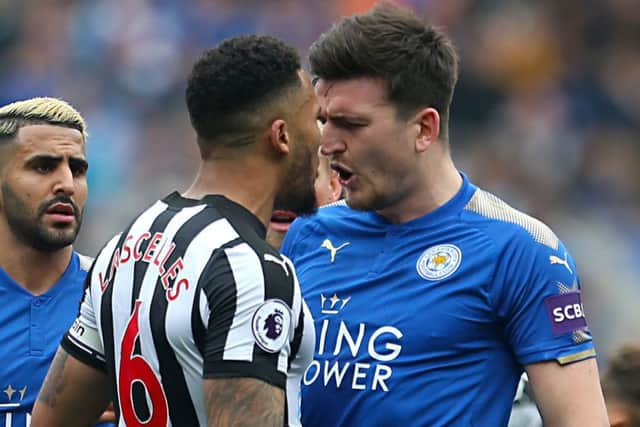 Newcastle Uniteds Jamaal Lascelles and Leicester Citys Harry Maguire exchange words.