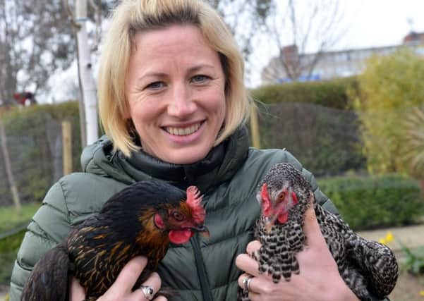 Alice House Hospice fundraising manager Rebecca Jobson with hospice chickens Paxo and Martha.