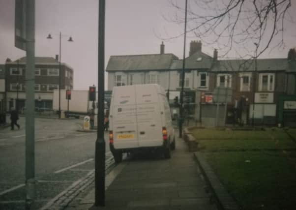 A van parked on pavement in Beach Road