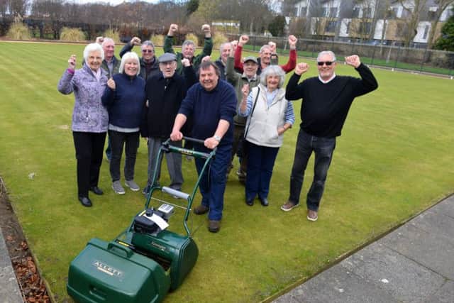 Whitburn Bowling Club new grass cutter funded by themselves. Chairman Derek Wilson with club members