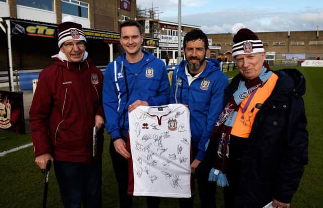 John Barnes, far right, is presented with a signed South Shields shirt by players Graeme Armstrong and Julio Arca, with friend Tony Ilott, far left. Picture by Kev Wilson.
