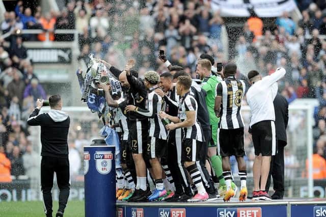 Newcastle's players celebrate after winning the Championship after the Barnsley game