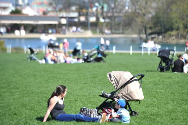 People enjoy the sun in the South Marine Park, in South Shields.