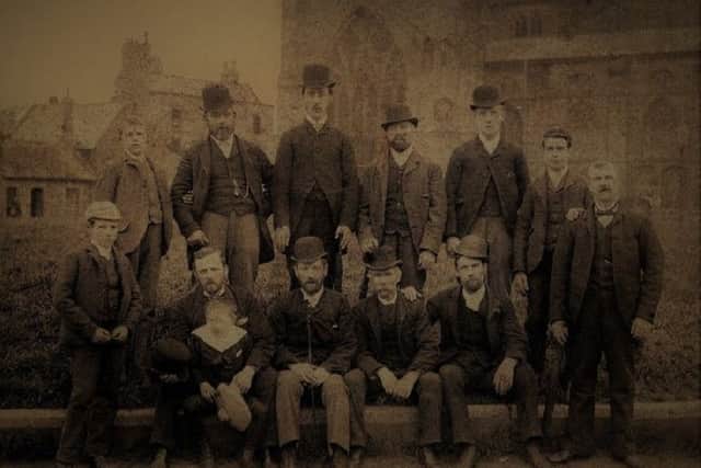 George Riddle, wood cutting machinist, fourth left on the front row.