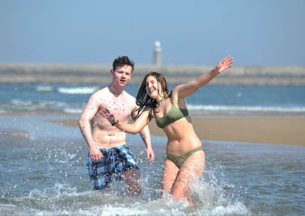 Students Nathan Wilde and Andie Vickers cool off on hottest day of the year, at Sandhaven Beach.