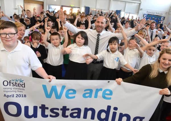 Epinay Business and Enterprise School hadteacher Chris Rue an pupils celebrate their outstanding Ofsted.