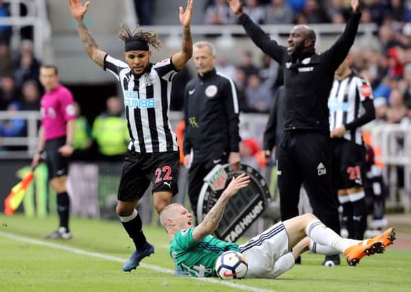 James McClean goes down under the close attention paid by Newcastle Uniteds DeAndre Yedlin as West Broms                                                             caretaker manager Darren Moore appeals for a free-kick.