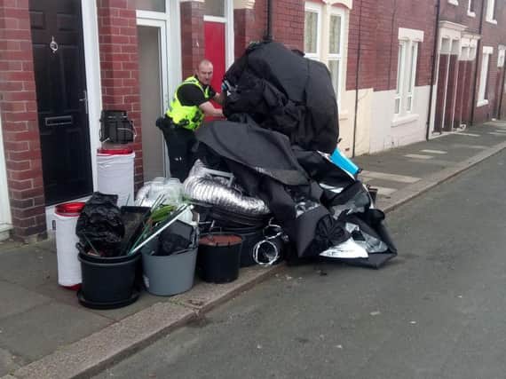 An officer with items removed from the house in Garrick Street in South Shields.