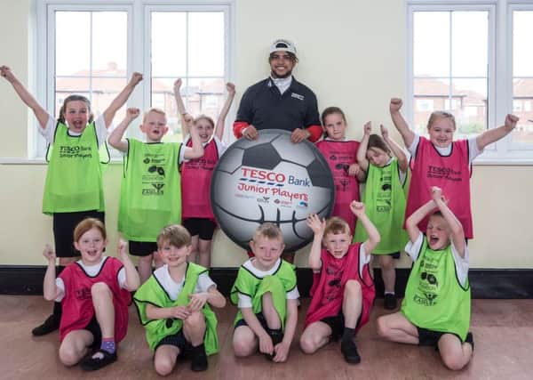 DeAndre Yedlin with pupils of Ivy Road Primary School, who were taking part in a Tesco Bank Junior Players coaching session led by the Newcastle United Community Foundation.