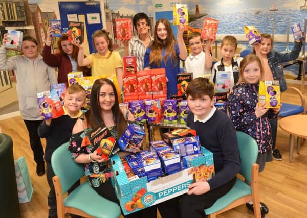 Lynn Davis of The People's Angels Easter Egg donation to Ben Holt for the Young Carer's group