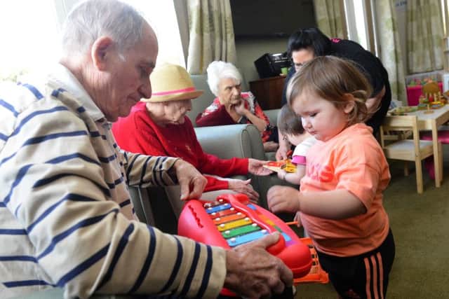 Youngsters new play group at Roseway House Care Home
Toddler Alyah Chisholm joins in with the residents.