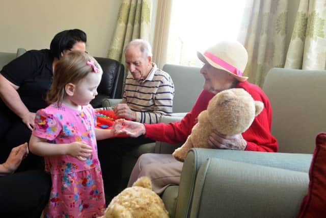 Youngsters new play group at Roseway House Care Home
Toddler Eva Robertson joins in with the residents.
