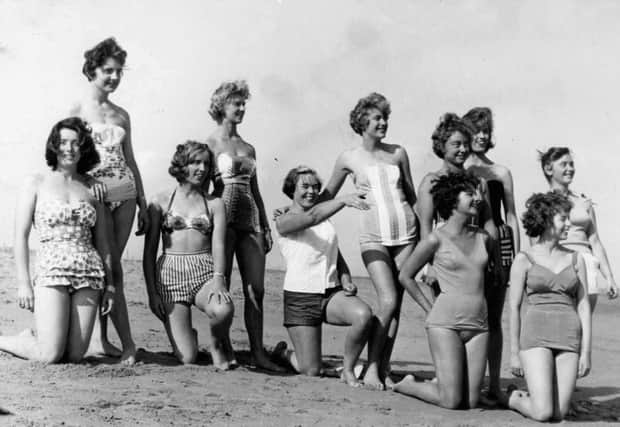Posing on the beach in 1961 are members of the cast of South Pacific.