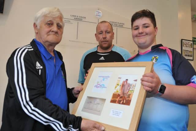 Mainsforth Cricket club chairman Tony Johns and captian John Cavanagh, receive a momento from Liam's brother Zack.