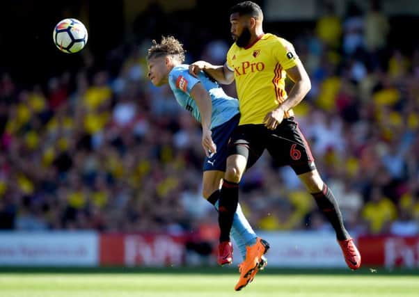 Newcastle's Dwight Gayle takes on Watford's Adrian Mariappa at Vicarage Road.